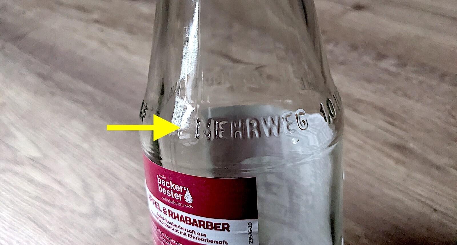 A glass bottle with an embossed "Mehrweg"